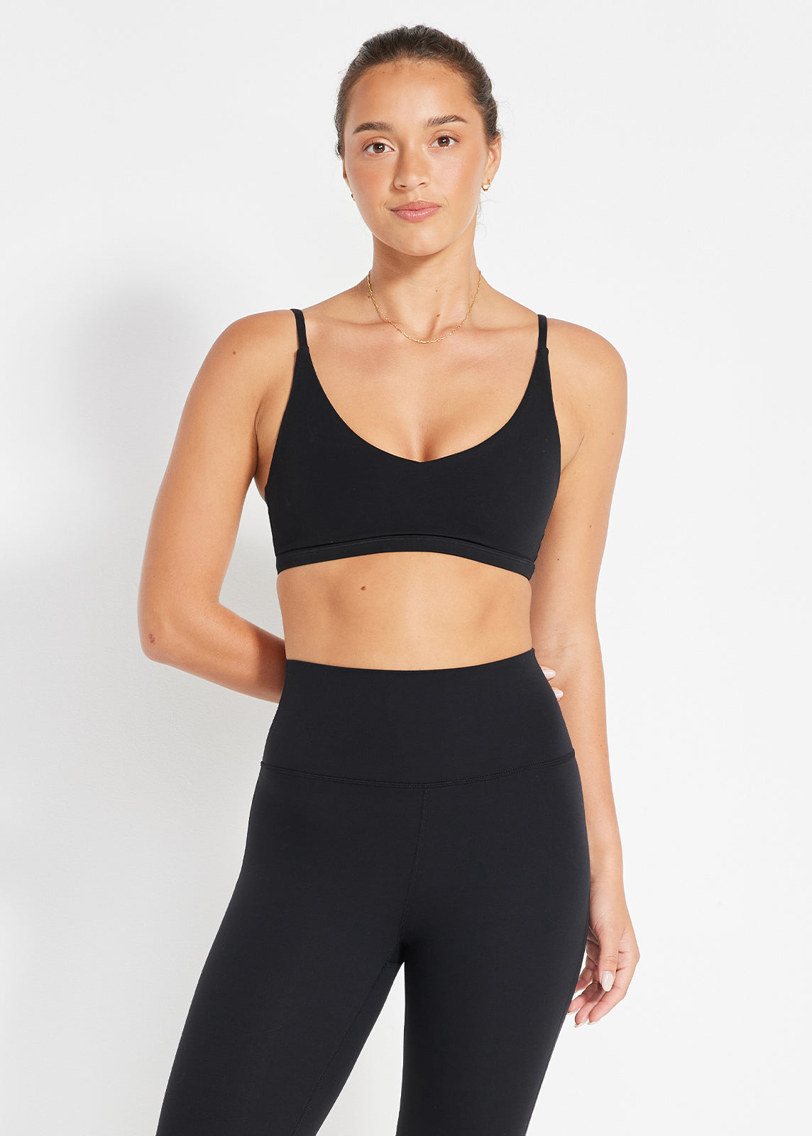 Black strappy bralette and high-rise leggings with soft scoop neckline
