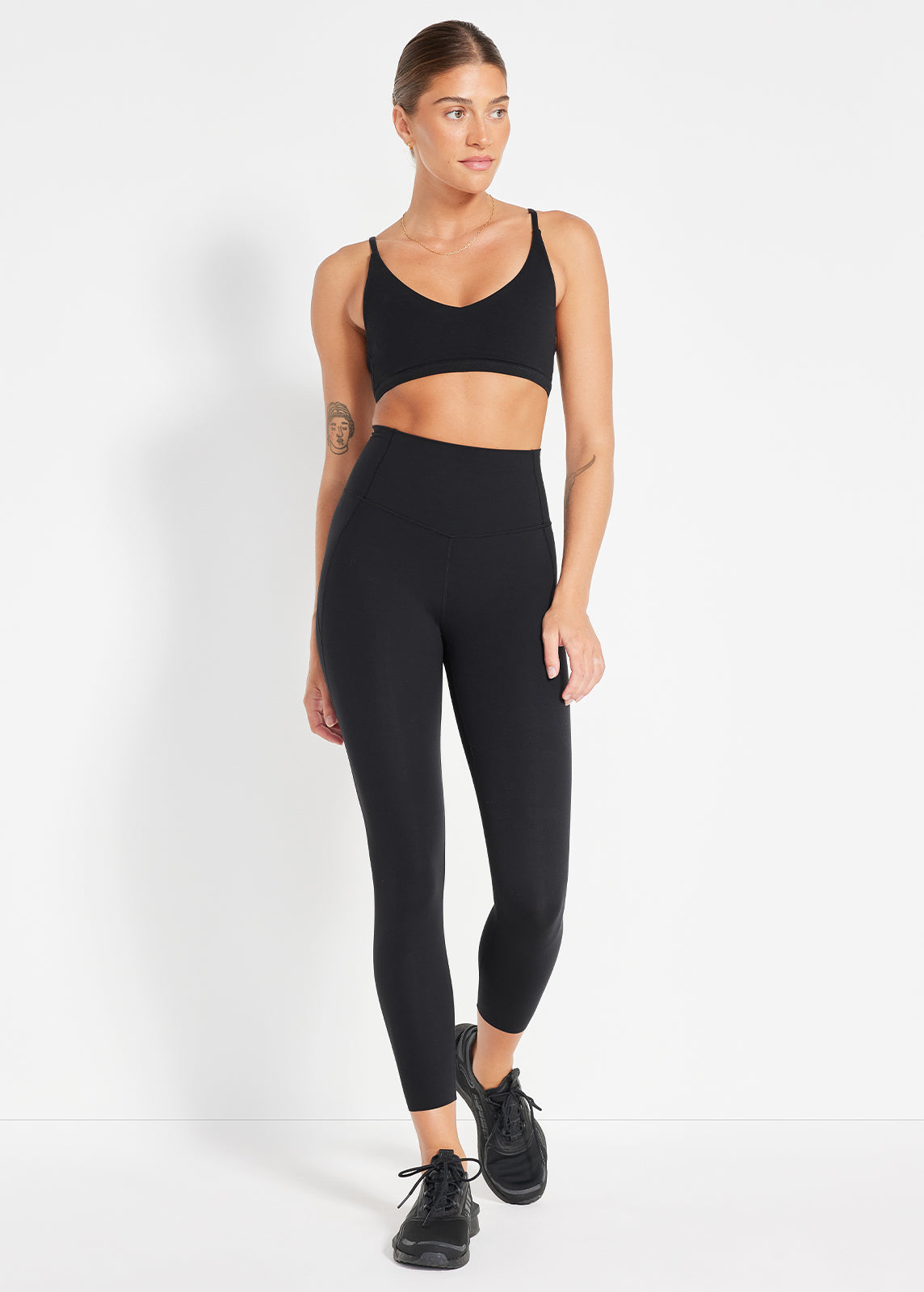 Model wearing black V-neck crop and high-rise leggings made for everyday movement