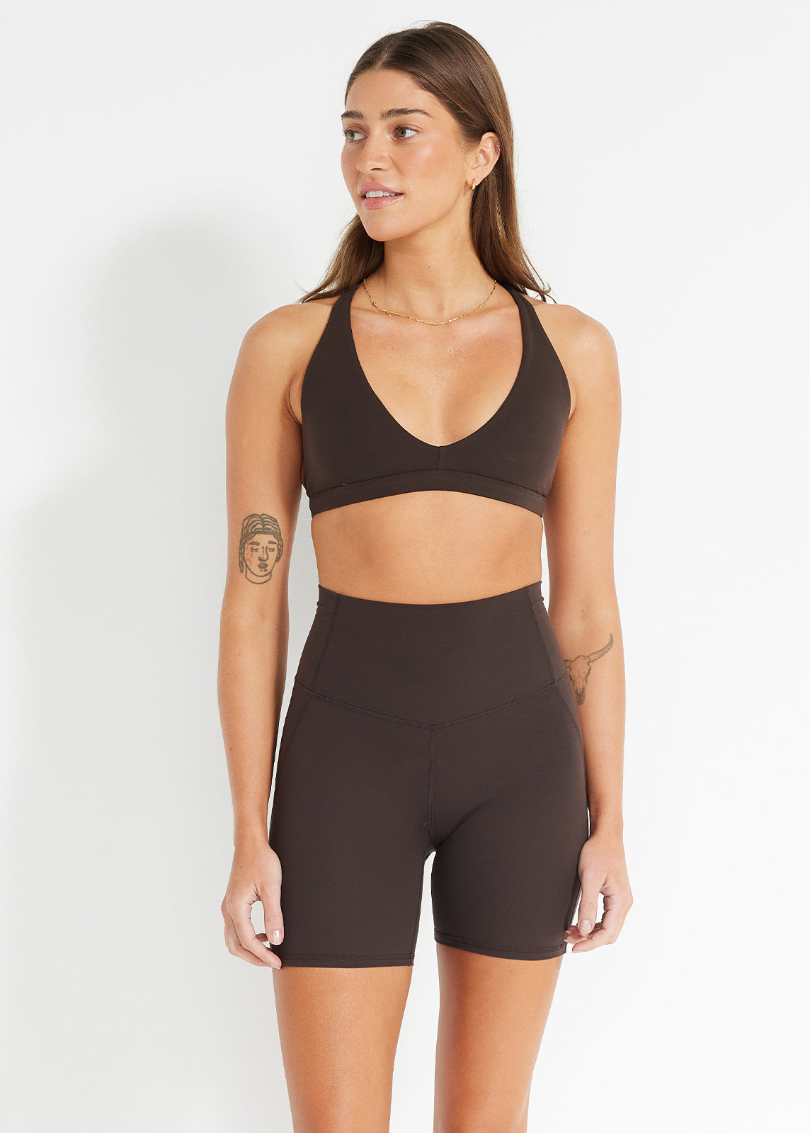 Model wearing chocolate V-neck crop and high-rise bike shorts made for comfort and ease