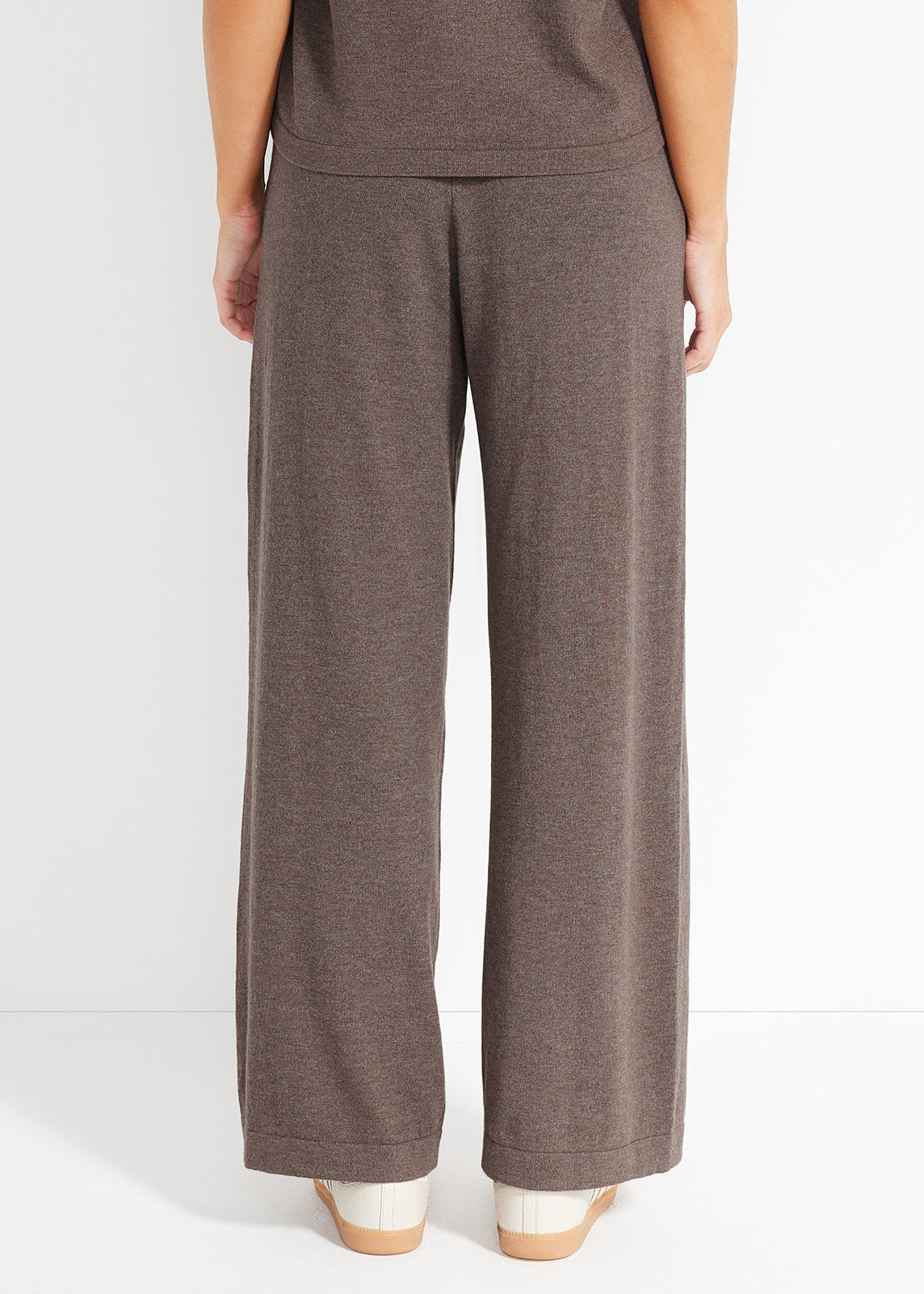 Back view of brown knit wide-leg lounge pants with relaxed hem and ribbed waistband