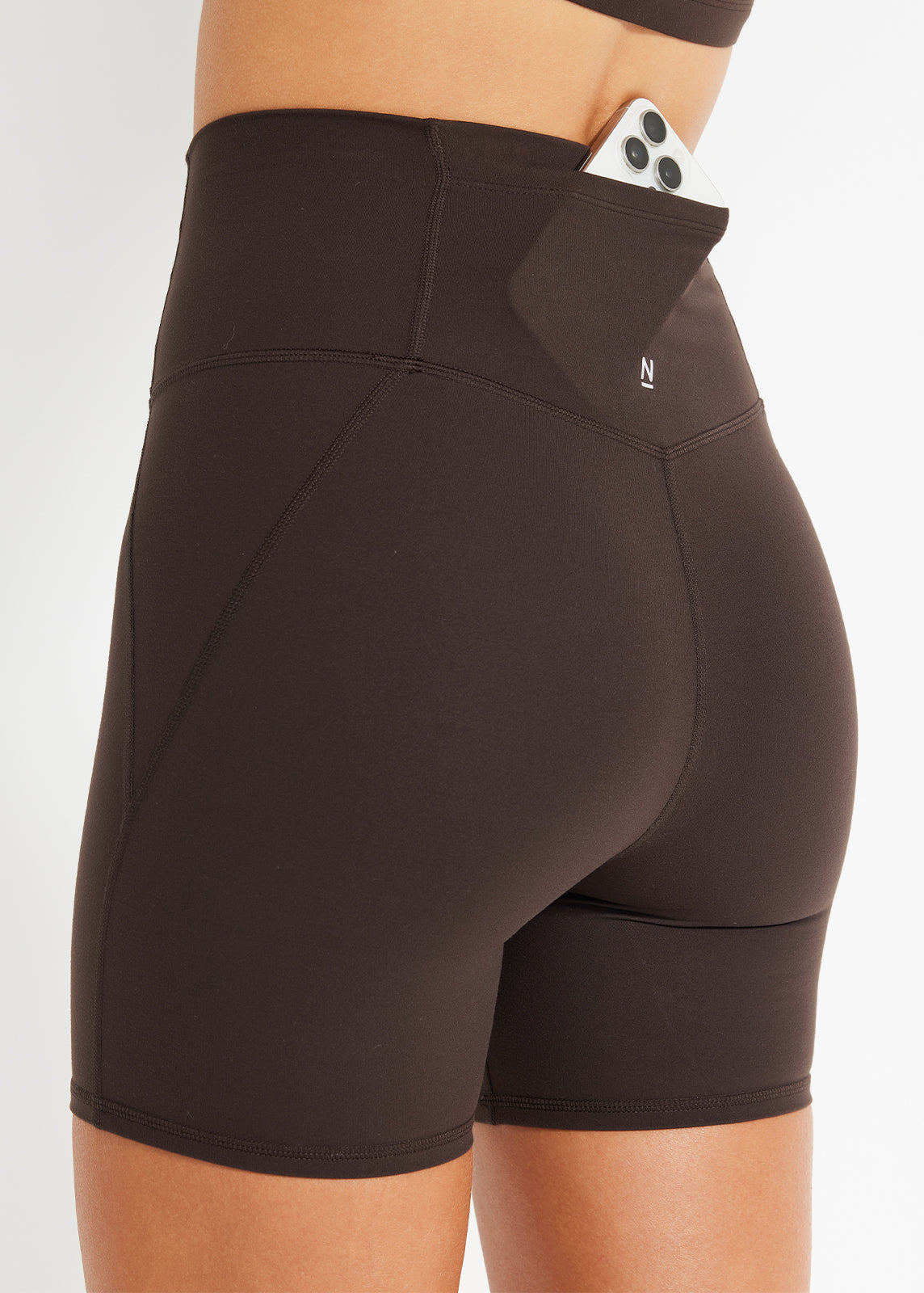Close-up of chocolate bike shorts with back pocket detail and sculpting seams