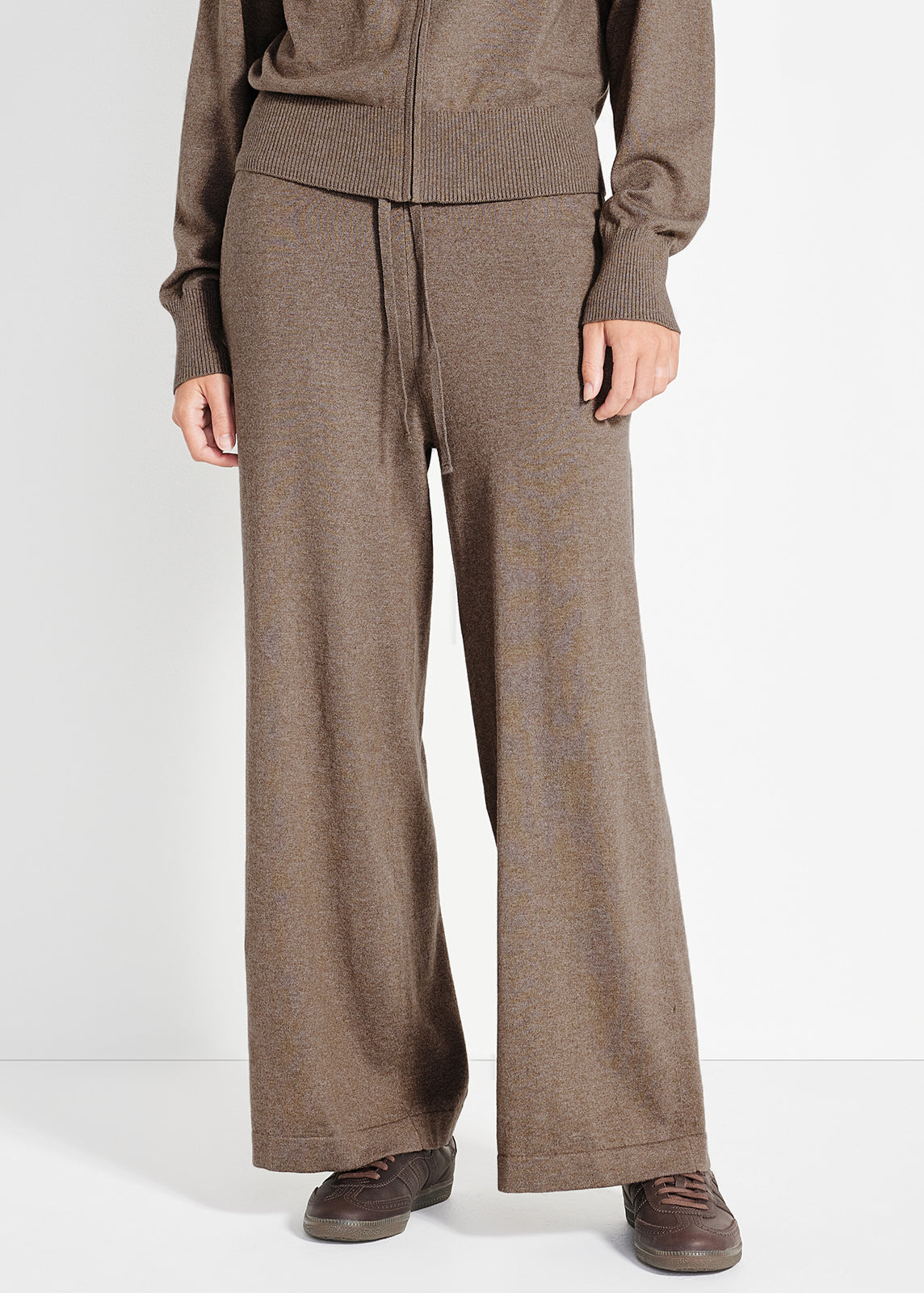 Model wearing brown knit lounge set featuring short sleeve top and matching wide-leg pants