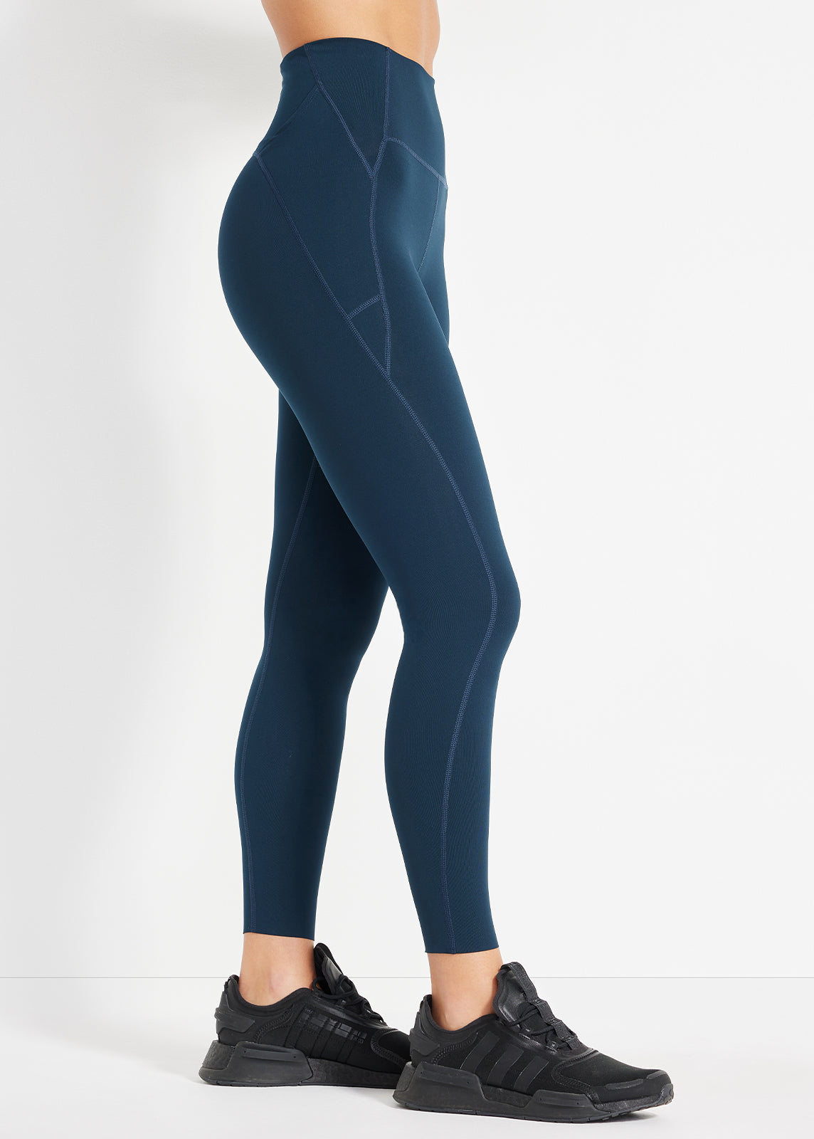 Side view of navy high-rise leggings showing sculpted seams and sleek finish