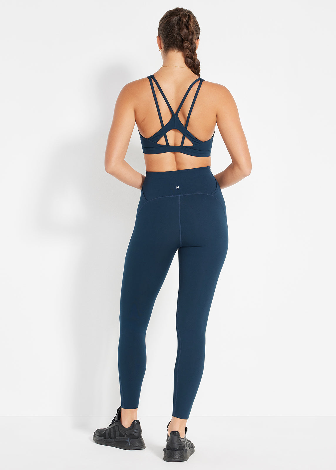 Back view of navy strappy bra and matching high-rise leggings for sleek support