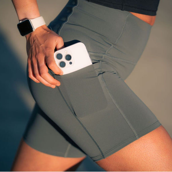 Close up of Nimble In Pace running shorts showing the side pocket holding a phone.